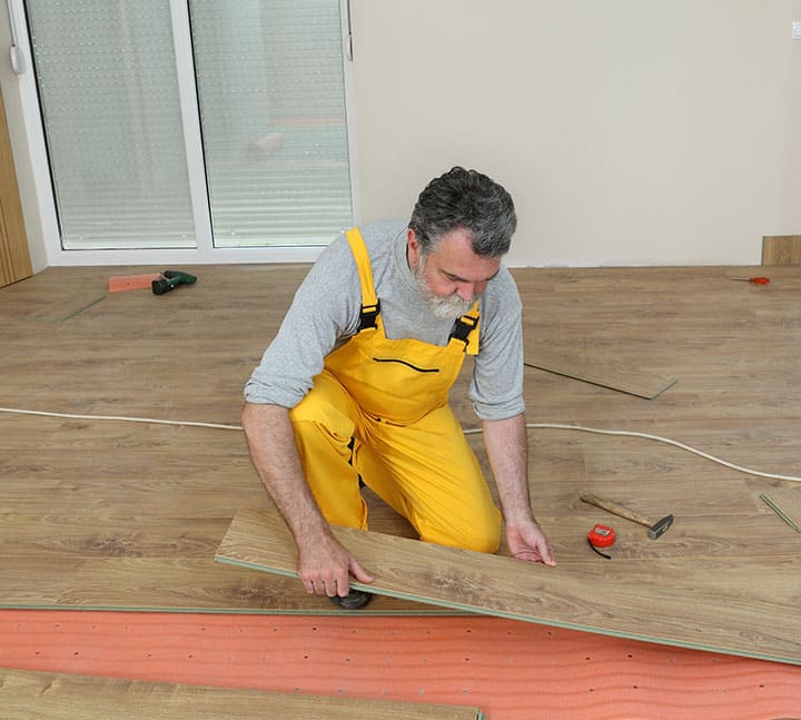 Man Installing Timber Wood Flooring - Totally Flooring In Gold Coast, QLD