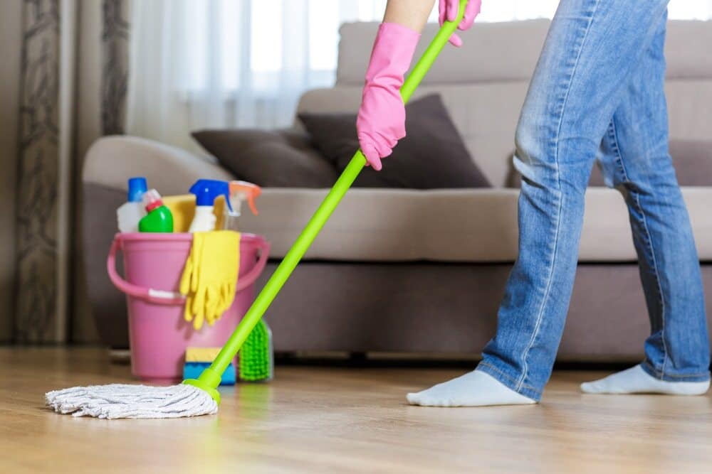 Woman Carefully Cleaning and Maintaining the Timber Flooring