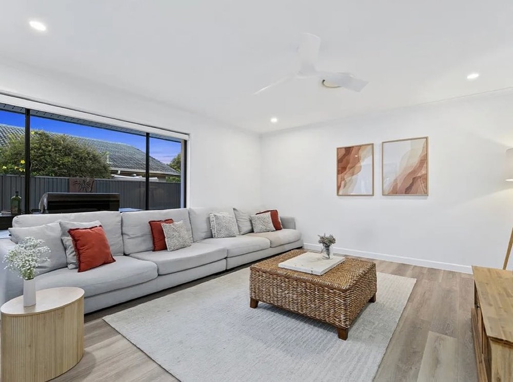 A Clean And Bright Living Room With Carpet