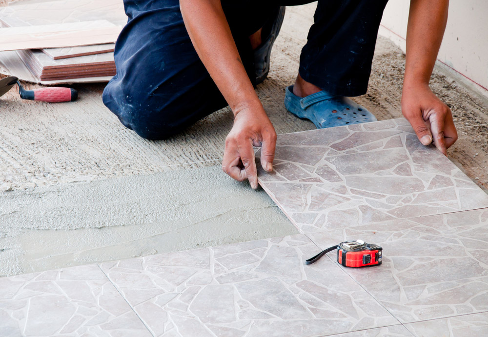 Man Laying out Tiles Outdoors