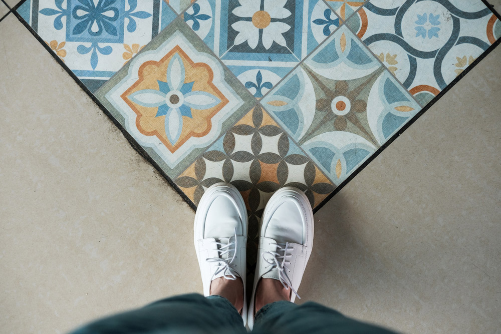 Woman Standing on Decorative Tiles