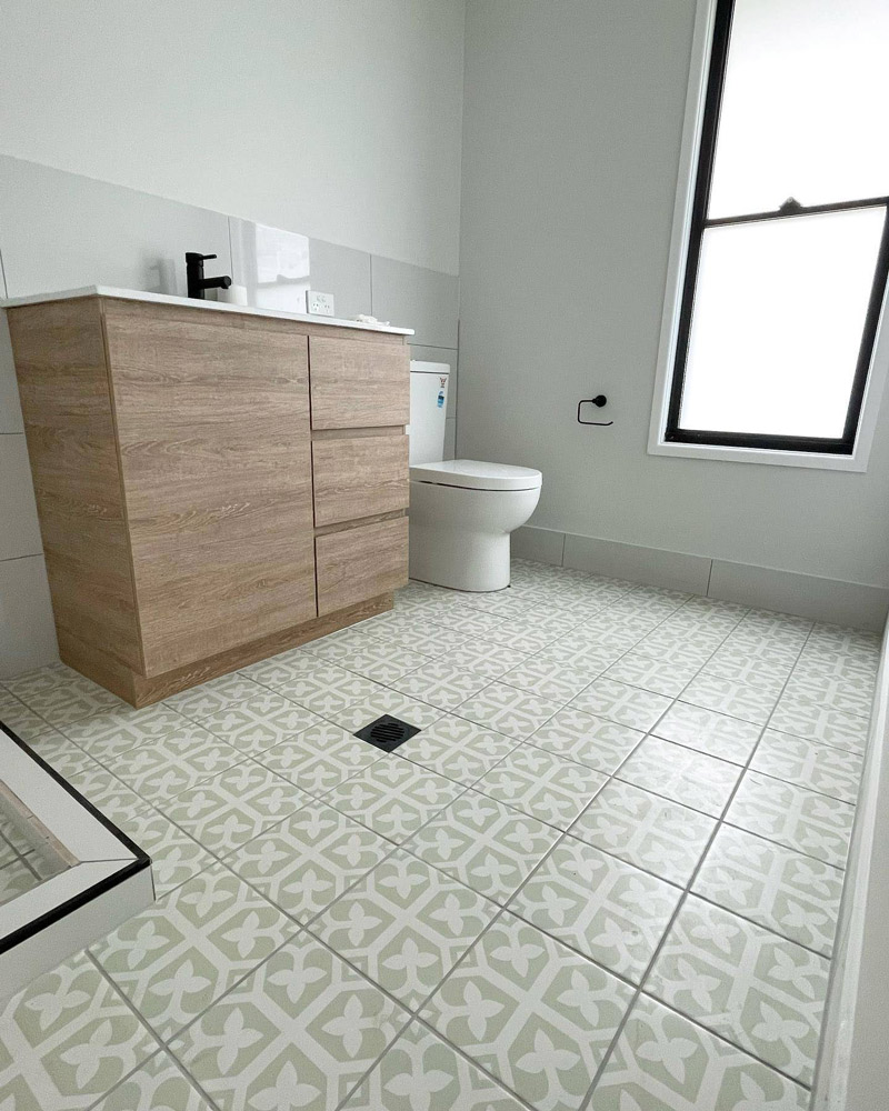 Bathroom with Decorated Tile Flooring