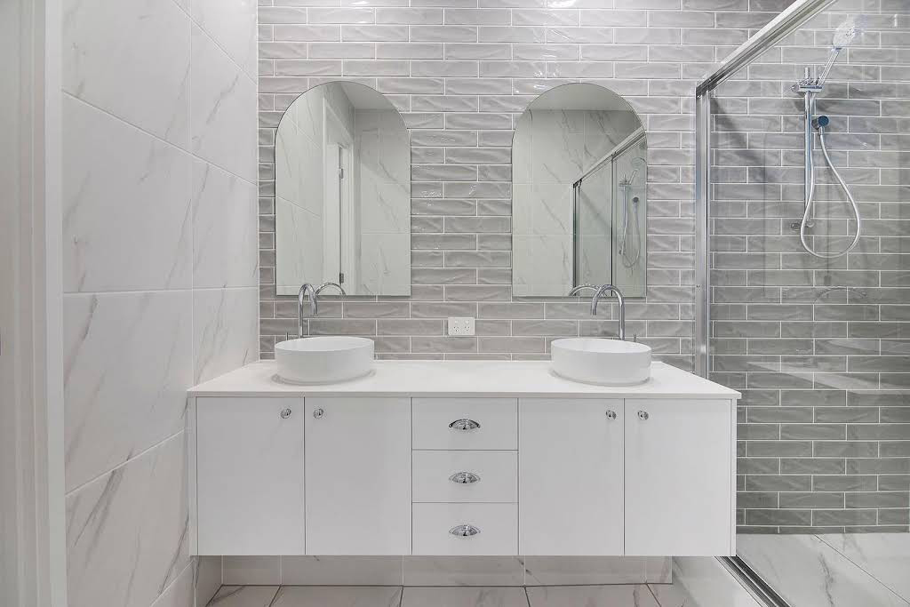 White Tiles Around the Cabinet and Sink of Bathroom